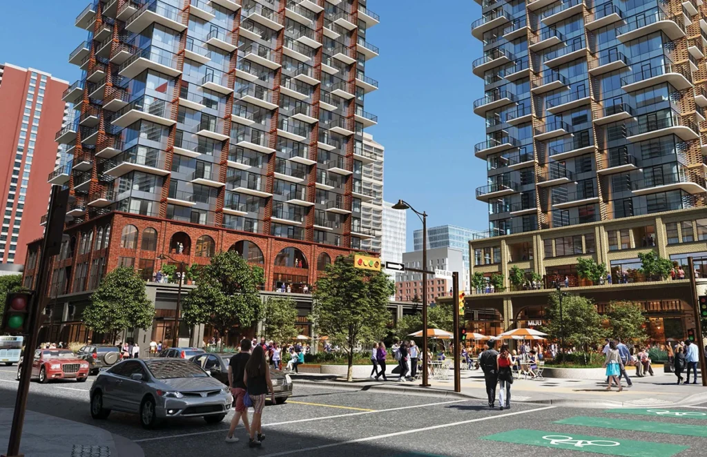 Beltline Block mixed-use high-rise development with storefronts, pedestrians, vehicles, and bike lanes in an urban downtown area.